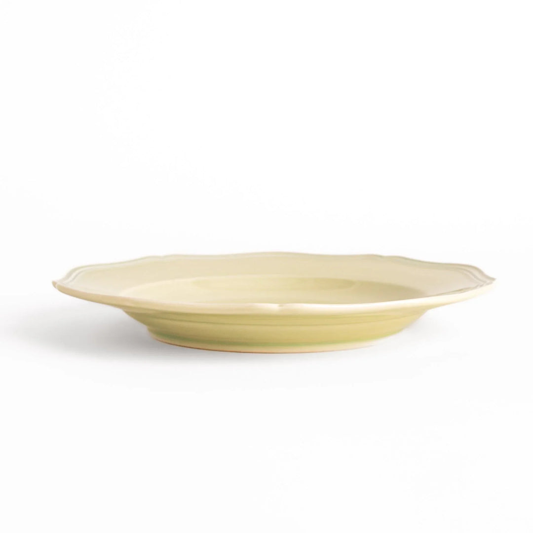 Pretty green dinner plate with a delicate scalloped edge, ideal for showcasing your culinary creations.