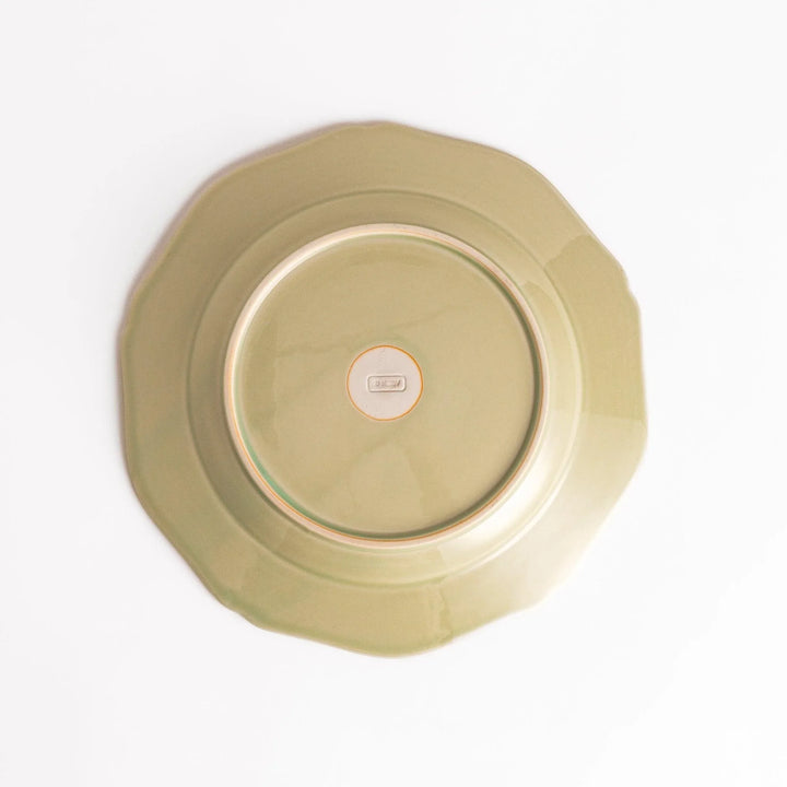 Pretty green dinner plate with a delicate scalloped edge, ideal for showcasing your culinary creations.