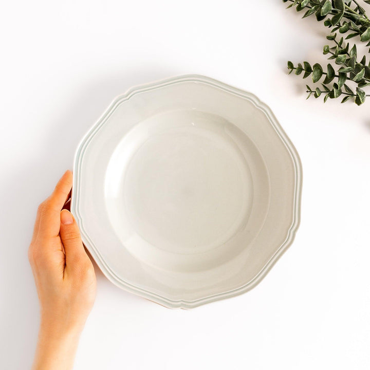 Pretty white dinner plate with a delicate scalloped edge, ideal for showcasing your culinary creations.