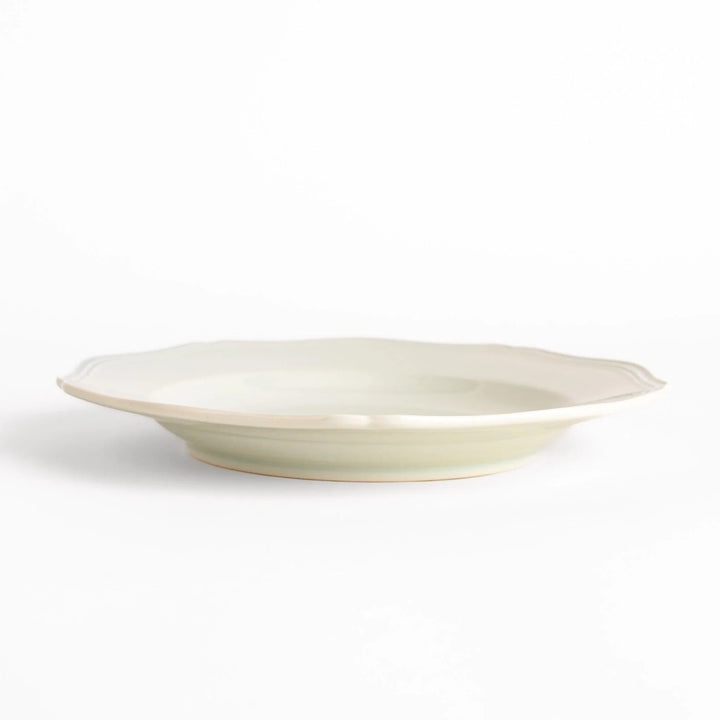 Pretty white dinner plate with a delicate scalloped edge, ideal for showcasing your culinary creations.
