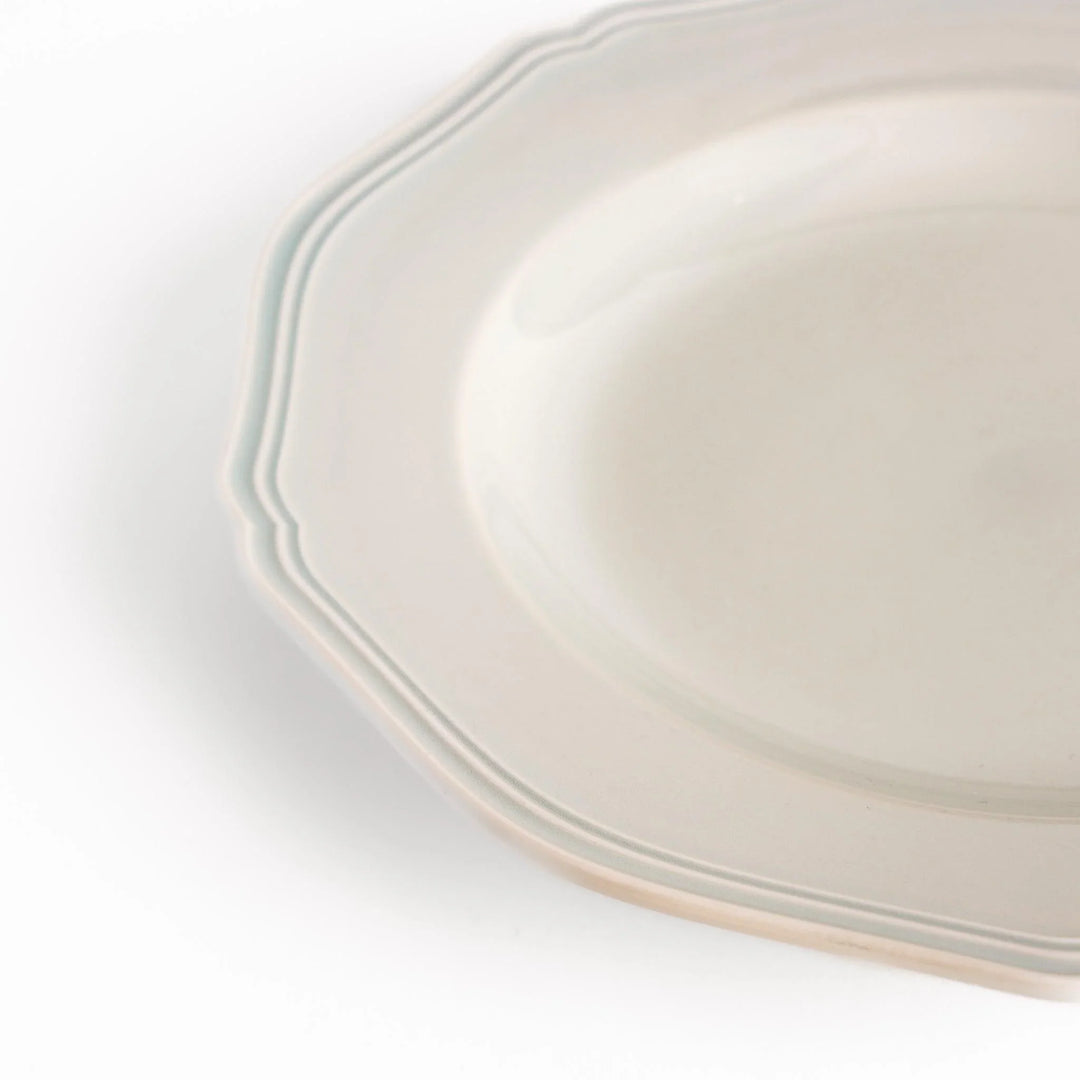 Pretty white dinner plate with a delicate scalloped edge, ideal for showcasing your culinary creations.