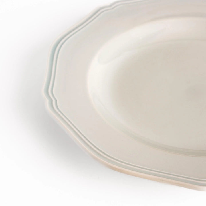 Pretty white dinner plate with a delicate scalloped edge, ideal for showcasing your culinary creations.
