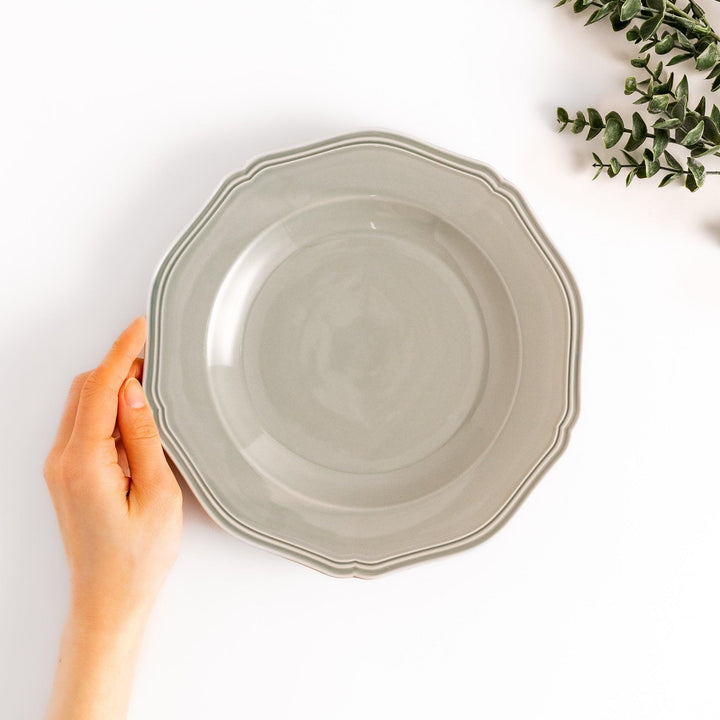 Pretty gray dinner plate with a delicate scalloped edge, ideal for showcasing your culinary creations.