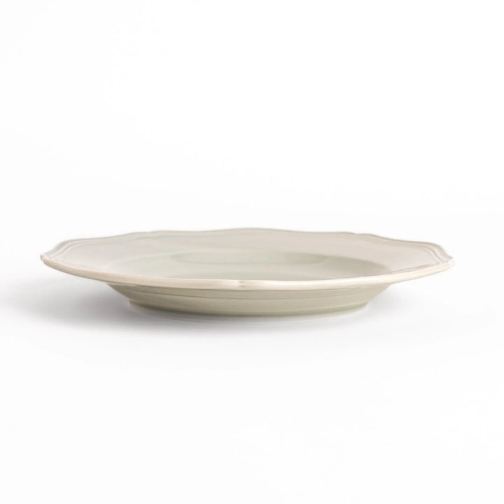 Pretty gray dinner plate with a delicate scalloped edge, ideal for showcasing your culinary creations.