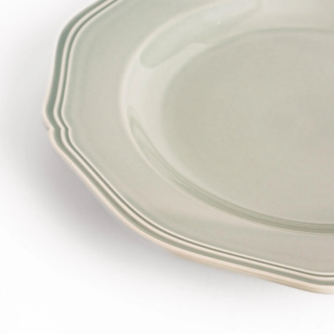 Pretty gray dinner plate with a delicate scalloped edge, ideal for showcasing your culinary creations.