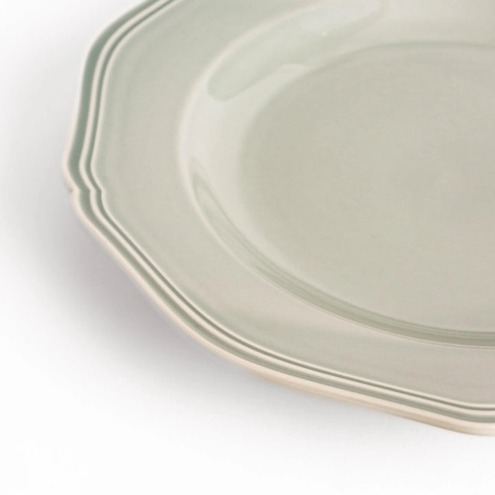 Pretty gray dinner plate with a delicate scalloped edge, ideal for showcasing your culinary creations.