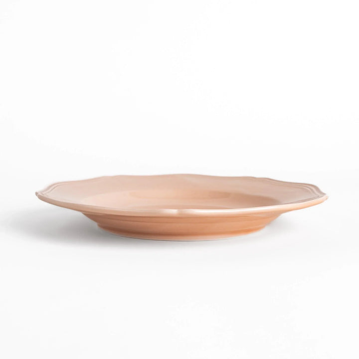 Pretty pink dinner plate with a delicate scalloped edge, ideal for showcasing your culinary creations.