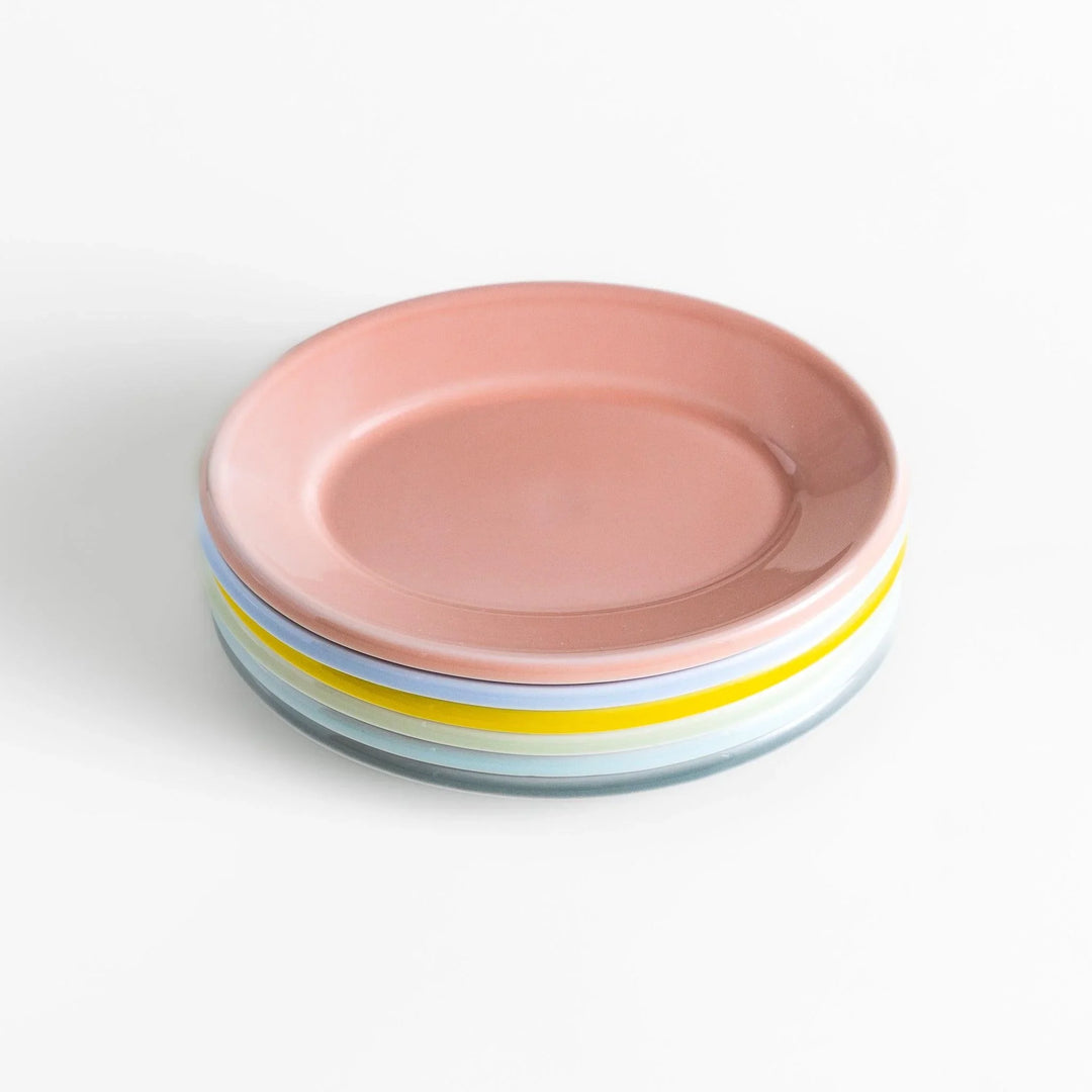 Stack of Japanese oval dessert plates in soft pastel colors, crafted with a smooth glossy finish for everyday elegance