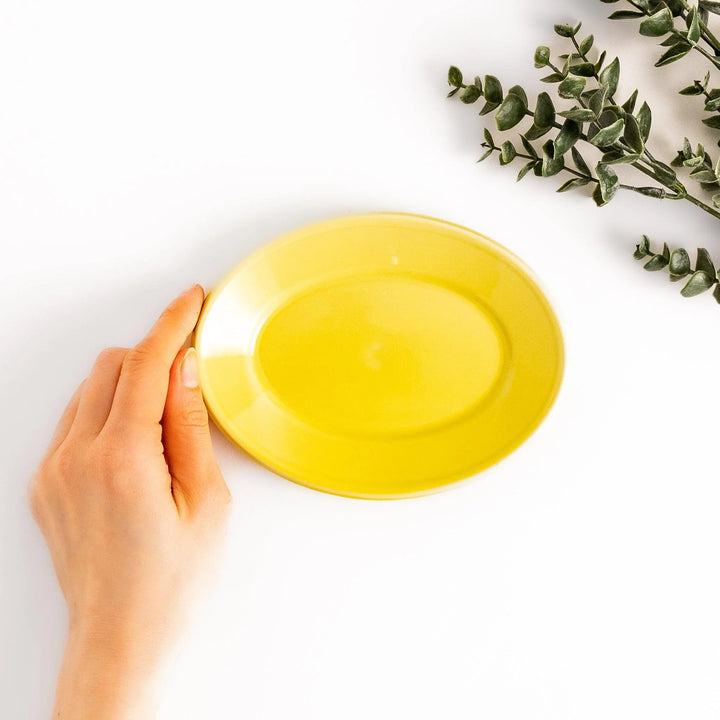 Durable and elegant yellow ceramic dessert plate, adding a pop of sunshine to your table setting.