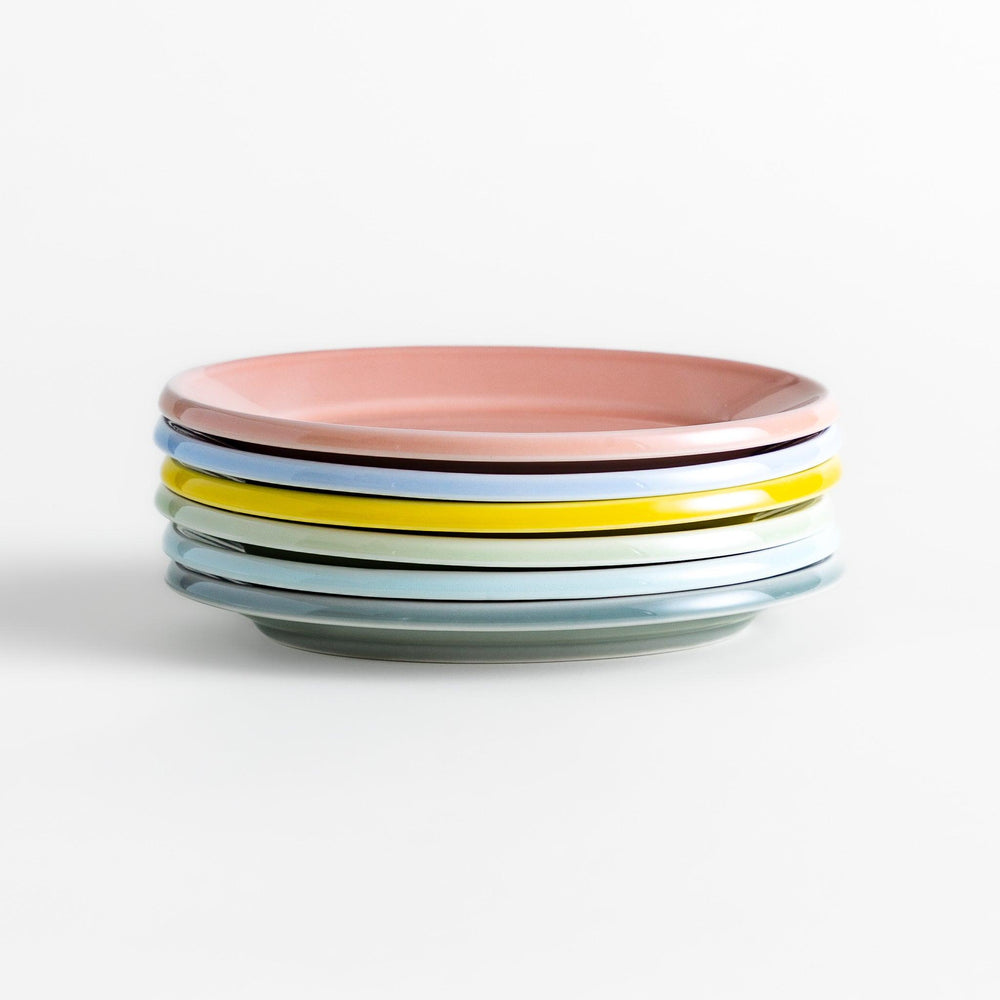 Stack of Japanese oval dessert plates in soft pastel colors, crafted with a smooth glossy finish for everyday elegance