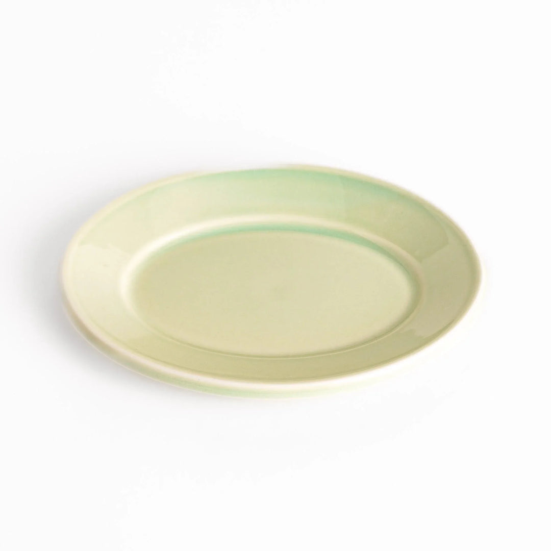Durable and elegant green ceramic dessert plate, adding a pop of sunshine to your table setting.