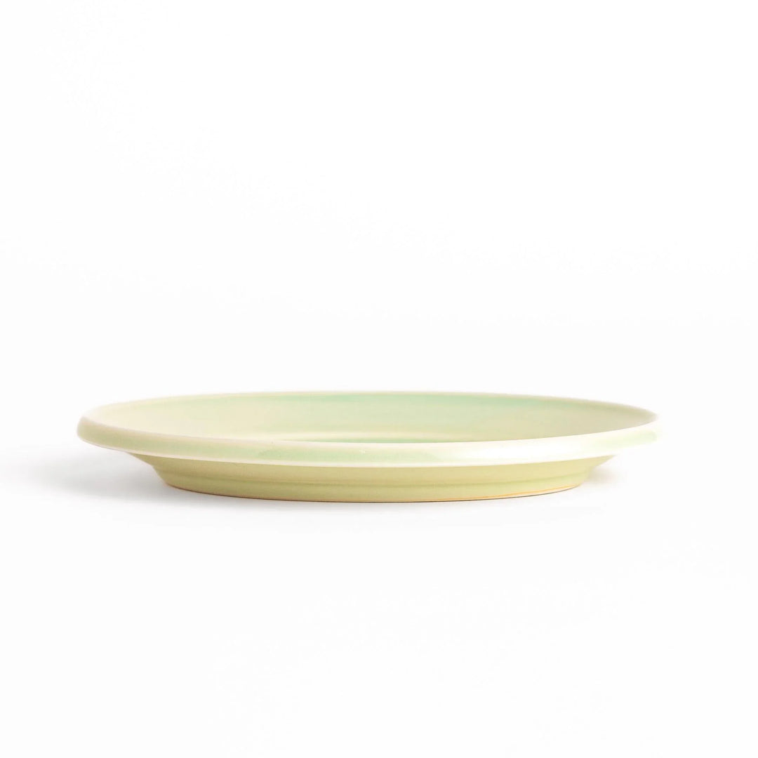 Durable and elegant green ceramic dessert plate, adding a pop of sunshine to your table setting.