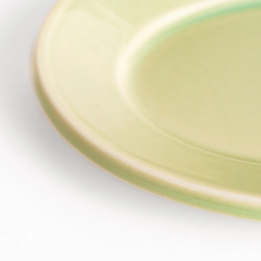 Durable and elegant green ceramic dessert plate, adding a pop of sunshine to your table setting.