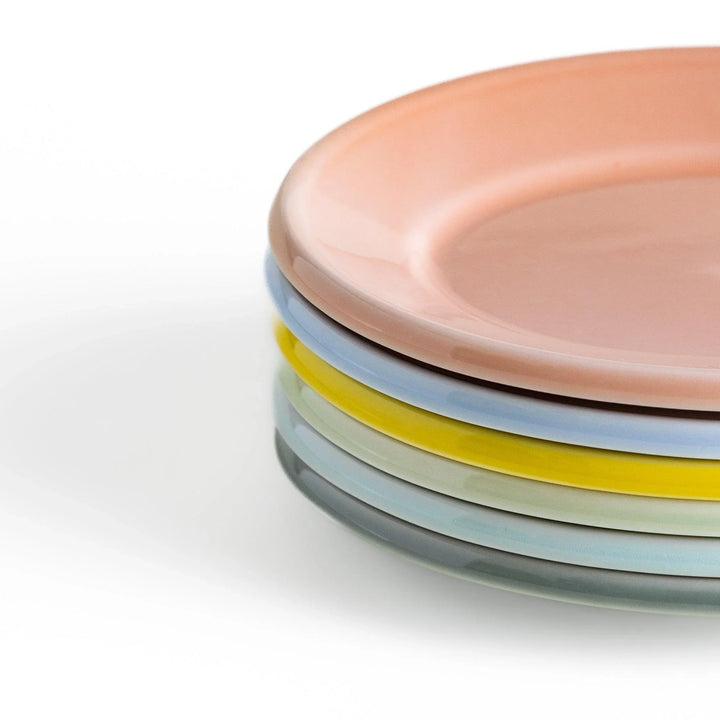 Stack of Japanese oval dessert plates in soft pastel colors, crafted with a smooth glossy finish for everyday elegance