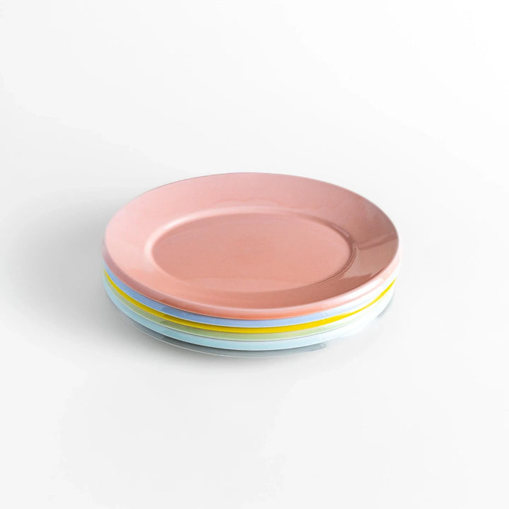 Stack of Japanese oval dinner plates in soft pastel tones with a smooth glossy finish, perfect for relaxed modern dining