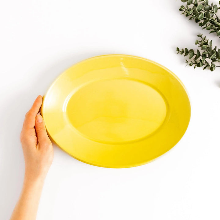 Durable and elegant yellow ceramic dinner plate, adding a pop of color to your table setting.