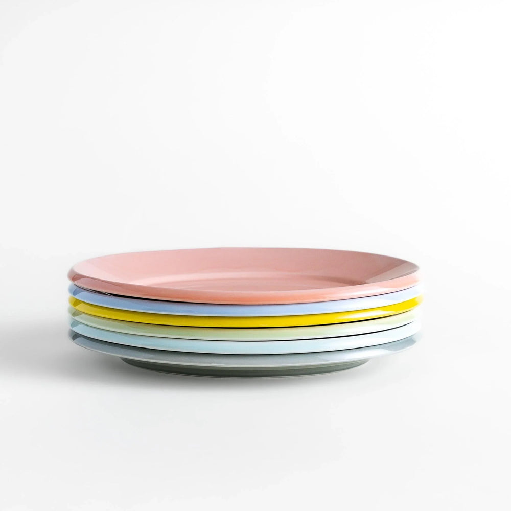 Stack of Japanese oval dinner plates in soft pastel tones with a smooth glossy finish, perfect for relaxed modern dining