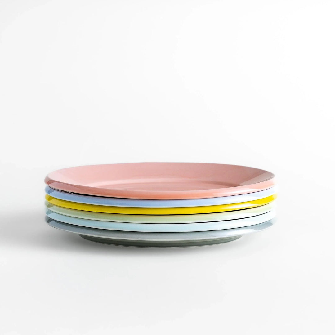 Stack of Japanese oval dinner plates in soft pastel tones with a smooth glossy finish, perfect for relaxed modern dining