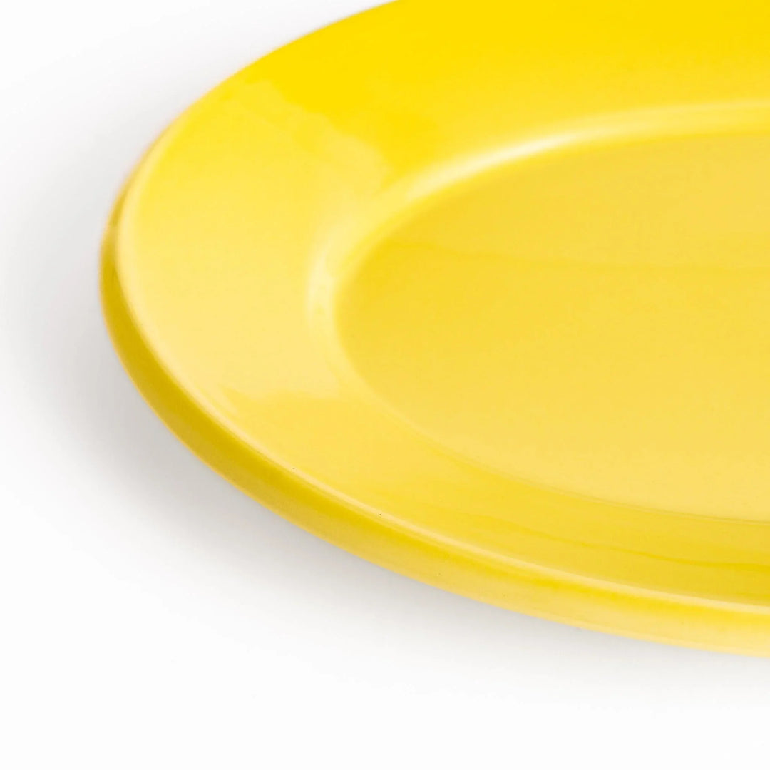 Durable and elegant yellow ceramic dinner plate, adding a pop of color to your table setting.