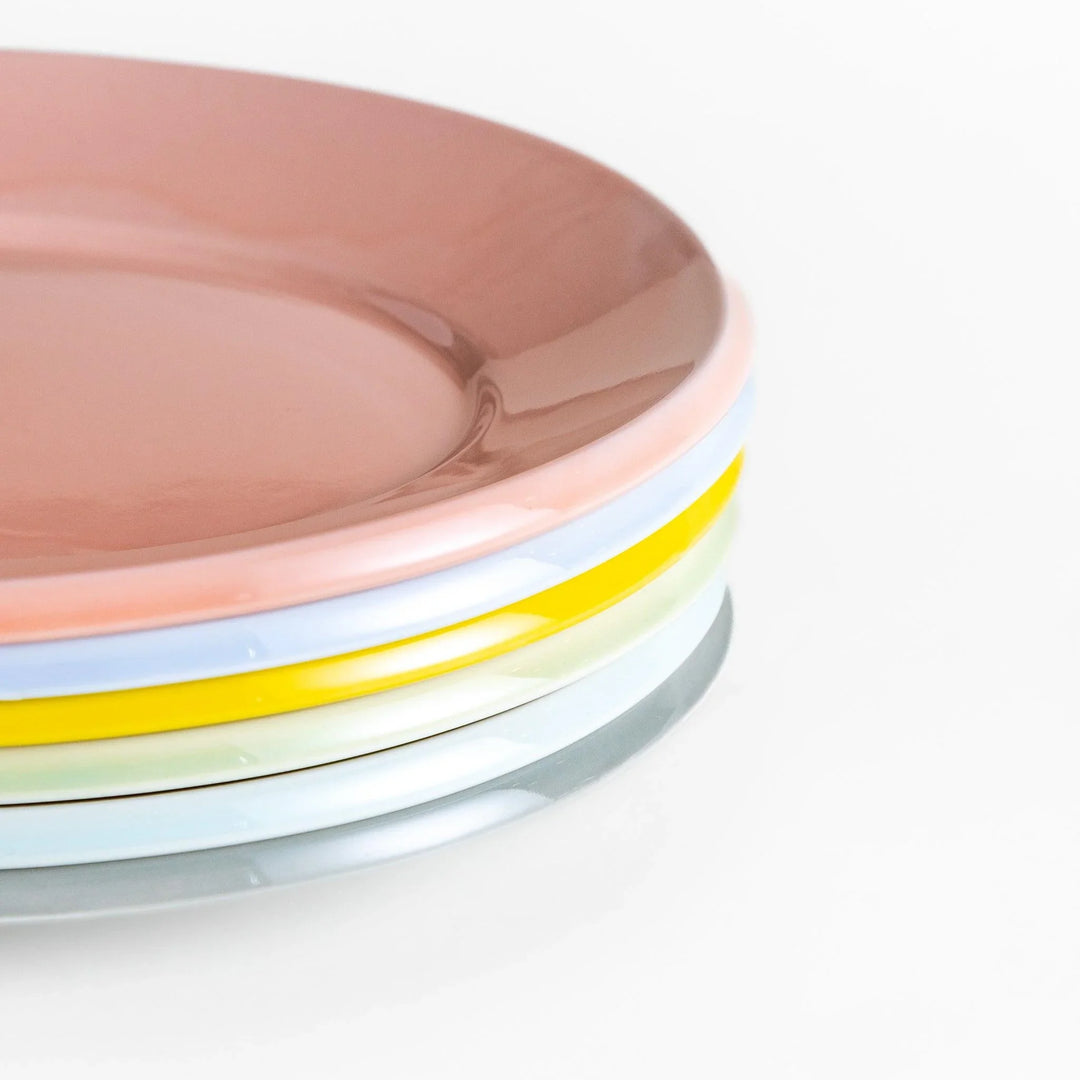 Stack of Japanese oval dinner plates in soft pastel tones with a smooth glossy finish, perfect for relaxed modern dining