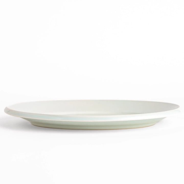 Durable and elegant white ceramic dinner plate, adding a pop of color to your table setting.