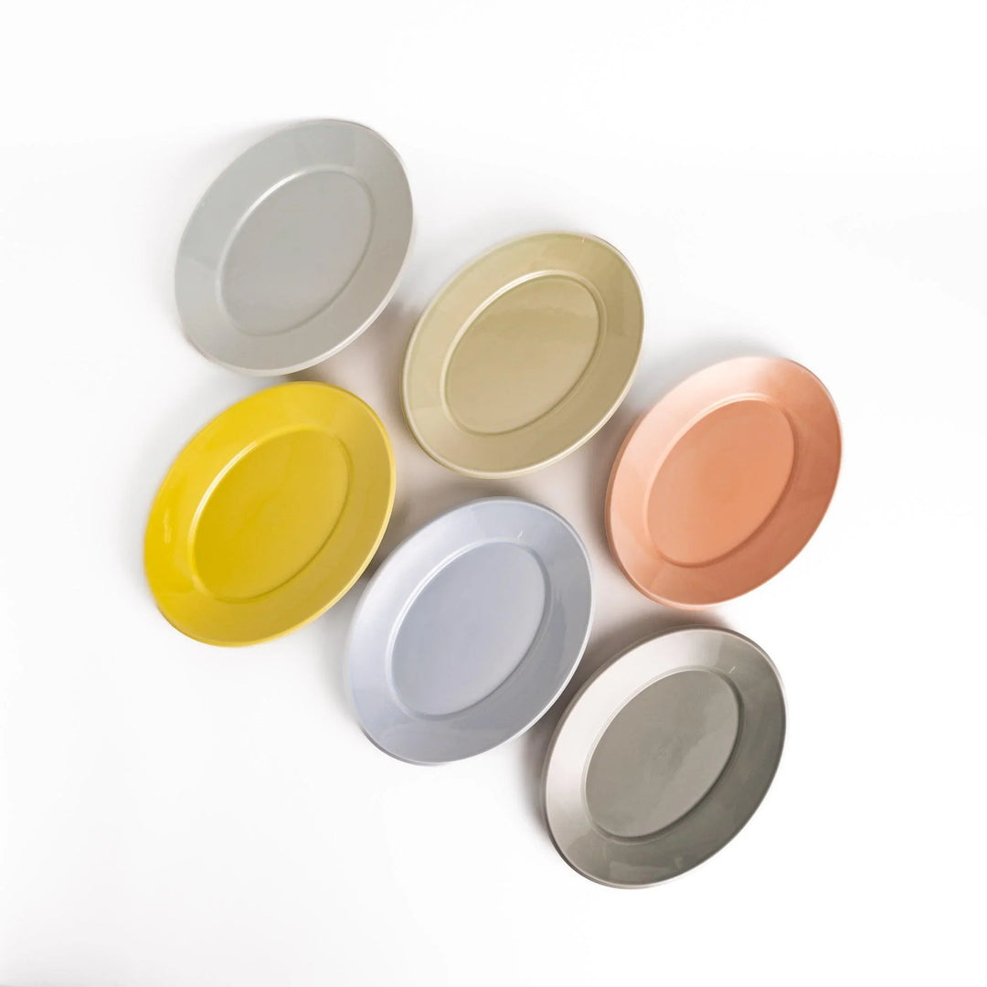 Japanese ceramic oval dinner plate shown in pastel colors yellow green blue gray and peach displayed on a white background.