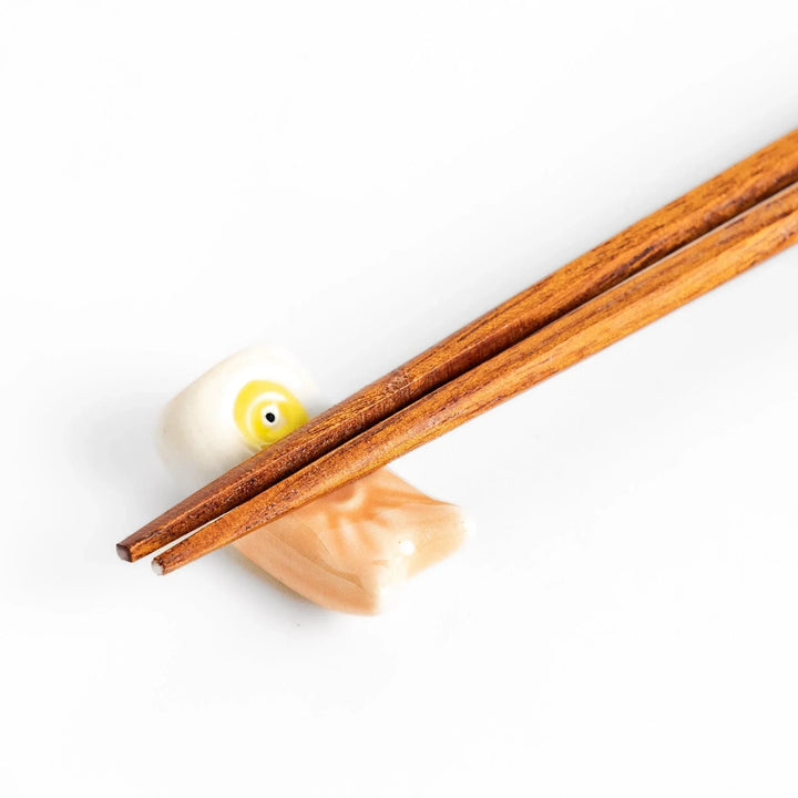 Peach carp streamer chopstick rest with a playful yellow eye design.