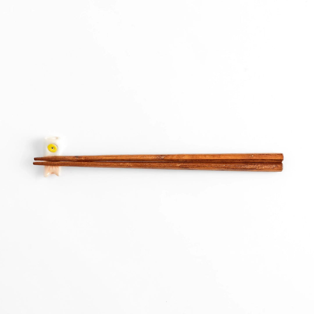 Peach carp streamer chopstick rest with a playful yellow eye design.