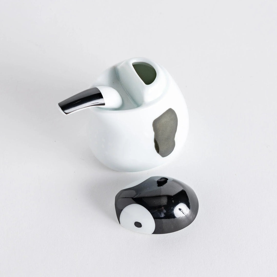 Penguin Soy Sauce Dispenser with the black lid removed, displaying the spout opening.