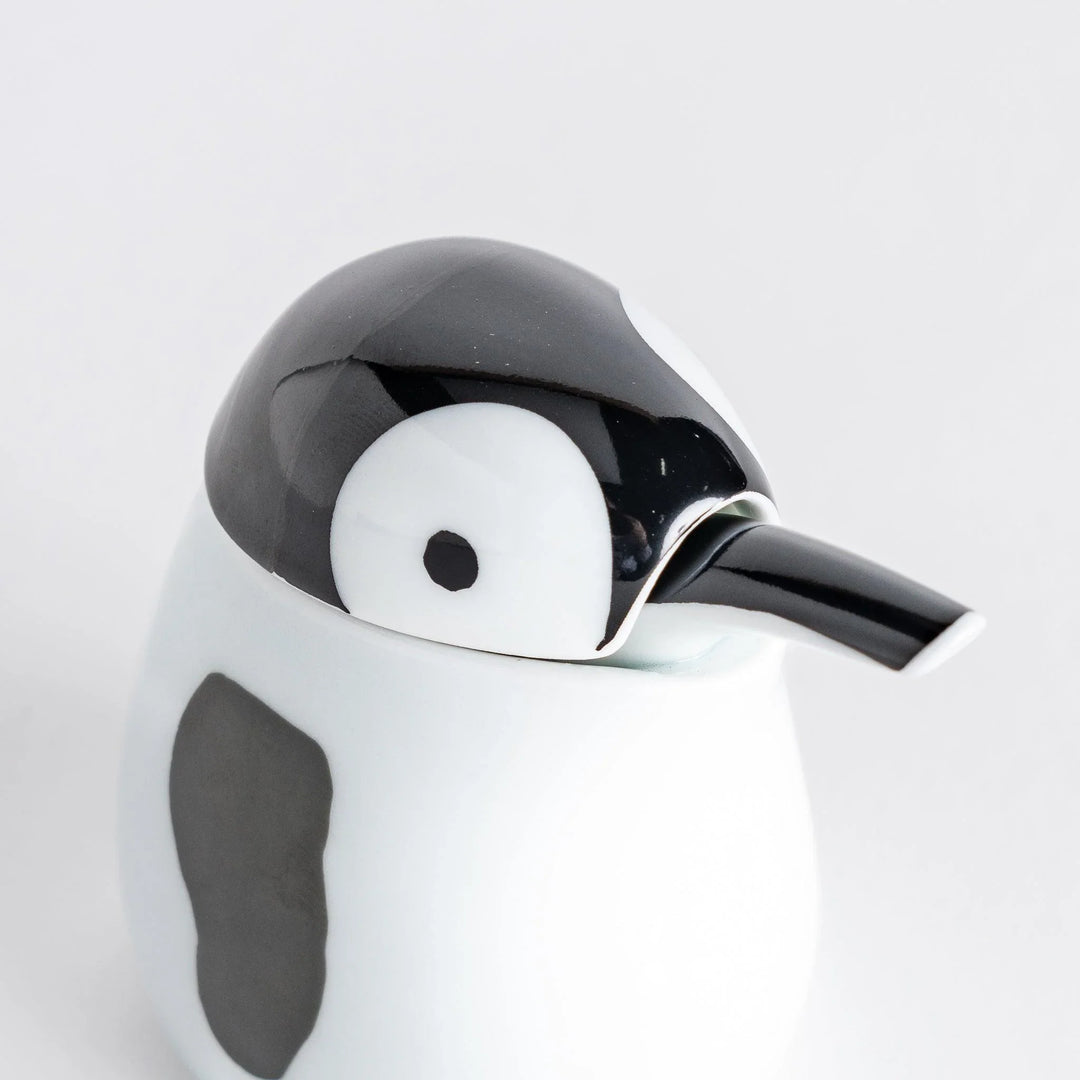 Close-up of the Penguin Soy Sauce Dispenser's face, showing black eye and smooth black beak.