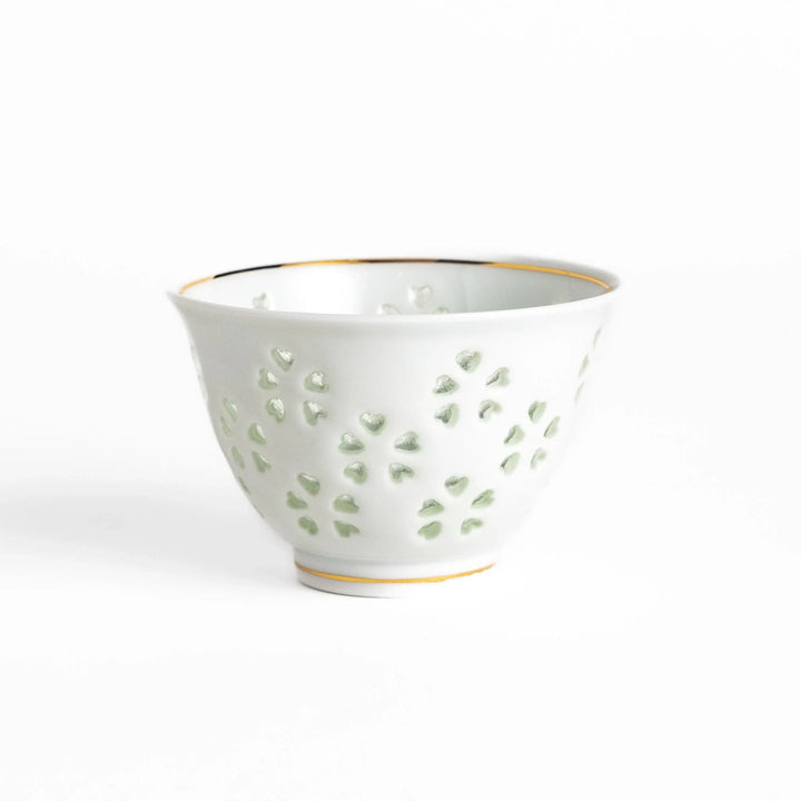 Delicate white teacup with a unique cut-out heart design, perfect for adding a touch of romance to your tea time.