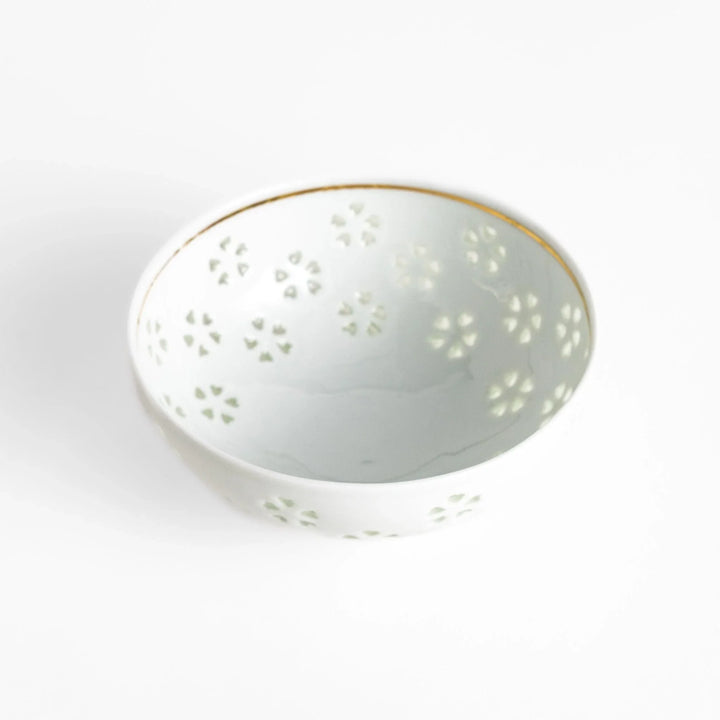 Elegant ceramic rice bowl with a delicate cut-out floral design, perfect for adding a touch of elegance to any meal.