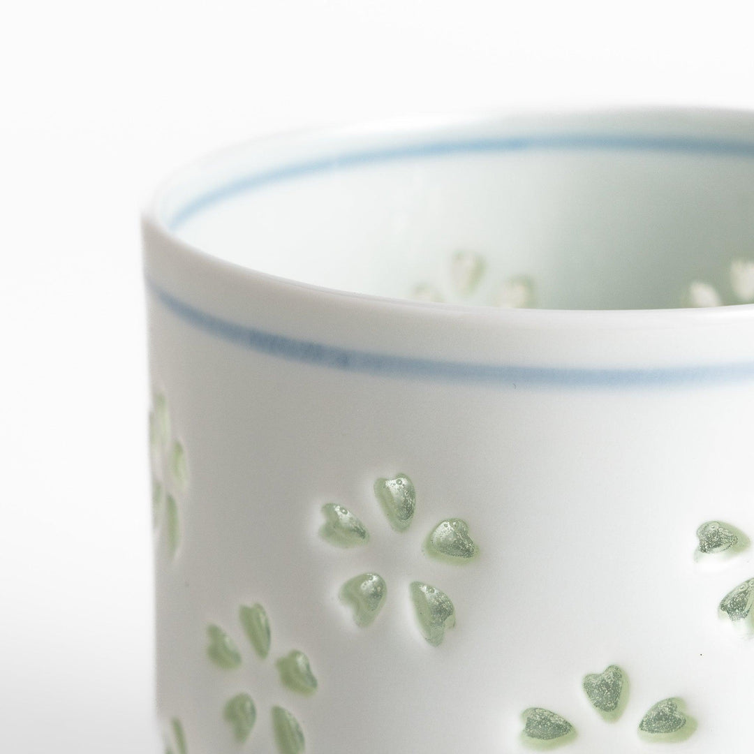 Unique ceramic glass featuring a delicate cut-out floral design, perfect for adding a touch of elegance to any table.