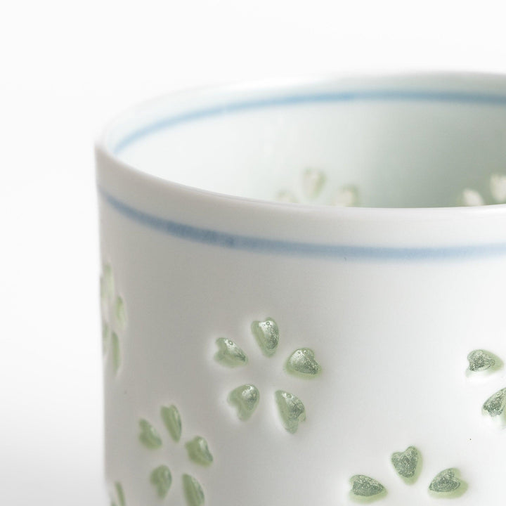 Unique ceramic glass featuring a delicate cut-out floral design, perfect for adding a touch of elegance to any table.