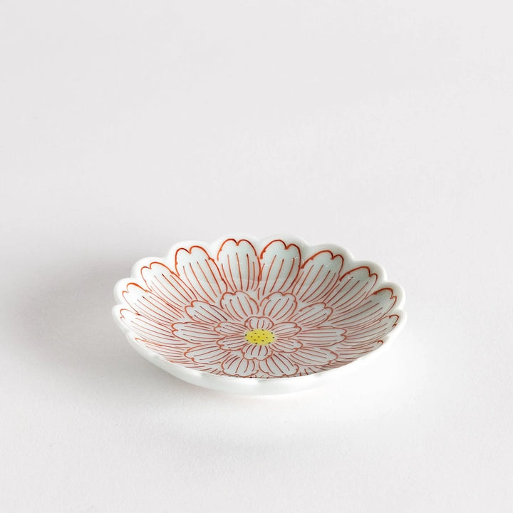 A small round dessert bowl with a delicate blue chrysanthemum pattern and scalloped edges.