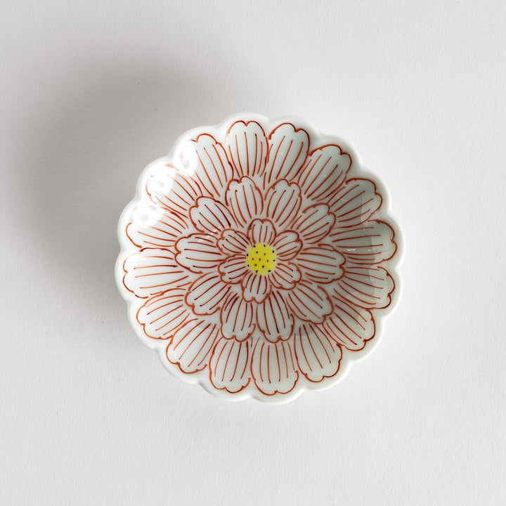 A small round dessert bowl with a delicate blue chrysanthemum pattern and scalloped edges.