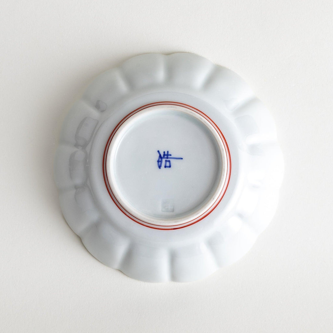 Small white porcelain dessert bowl with blue or red radiating lines for refined minimalist presentation.
