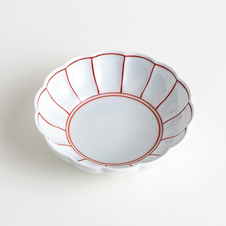 Small white porcelain dessert bowl with blue or red radiating lines for refined minimalist presentation.