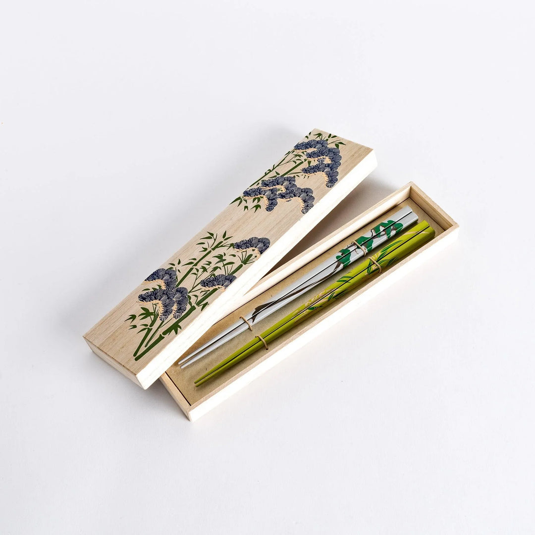 Chopsticks set in wooden box with intricate patterned lid offering elegant traditional Japanese design.