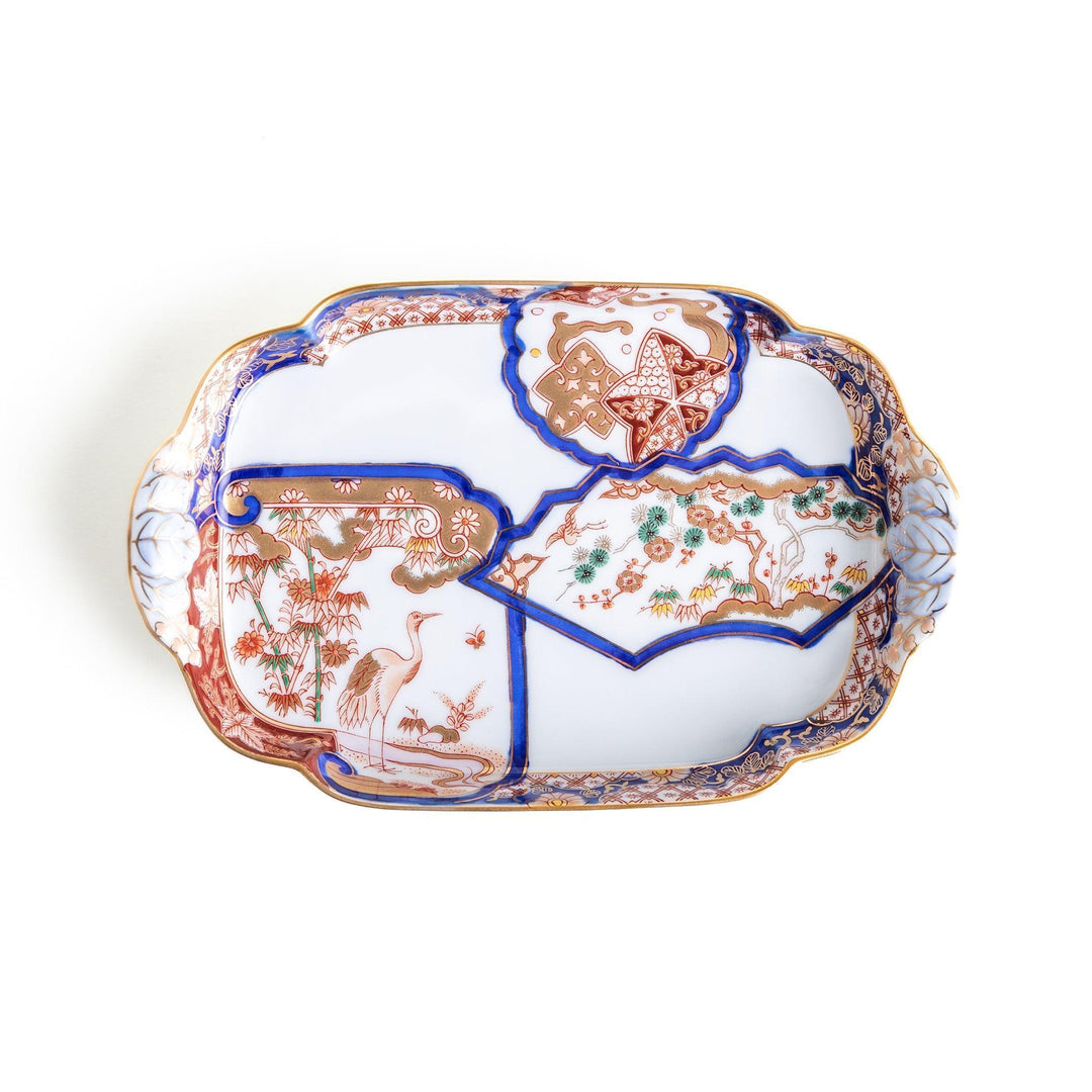 Rectangular salad plate with handles featuring cranes and trees bordered by red blue and gold patterns.