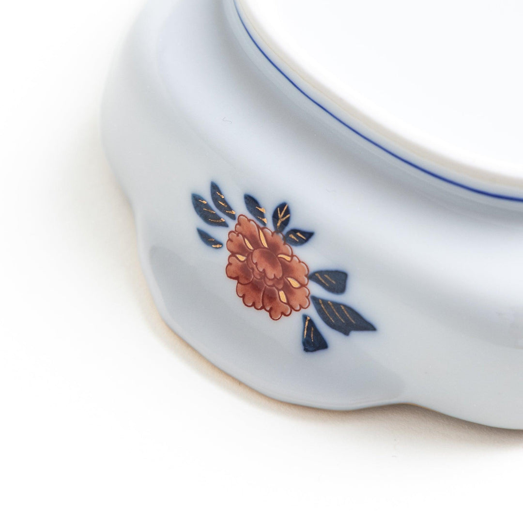 Rectangular salad plate with handles featuring cranes and trees bordered by red blue and gold patterns.