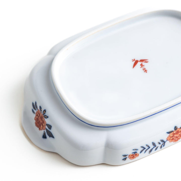 Rectangular salad plate with handles featuring cranes and trees bordered by red blue and gold patterns.