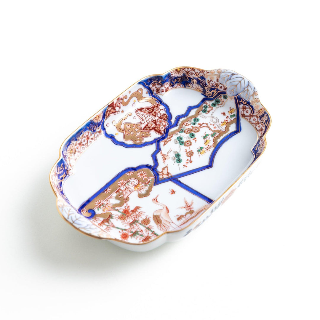 Rectangular salad plate with handles featuring cranes and trees bordered by red blue and gold patterns.