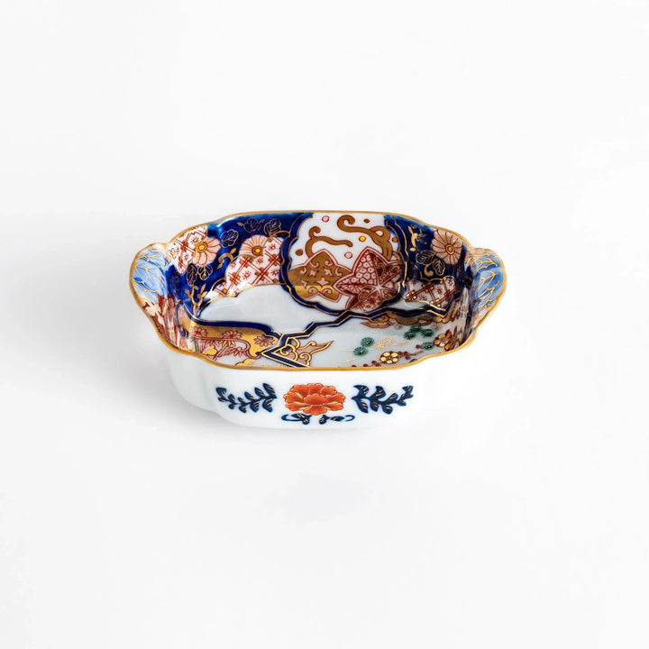 Vibrant condiment bowl with pine bamboo and plum motifs cranes and gold details and flared edge design.