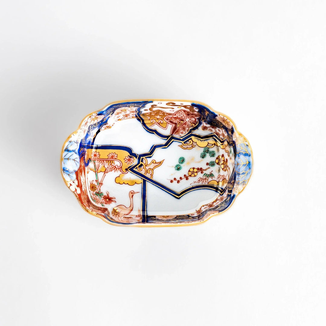 Vibrant condiment bowl with pine bamboo and plum motifs cranes and gold details and flared edge design.