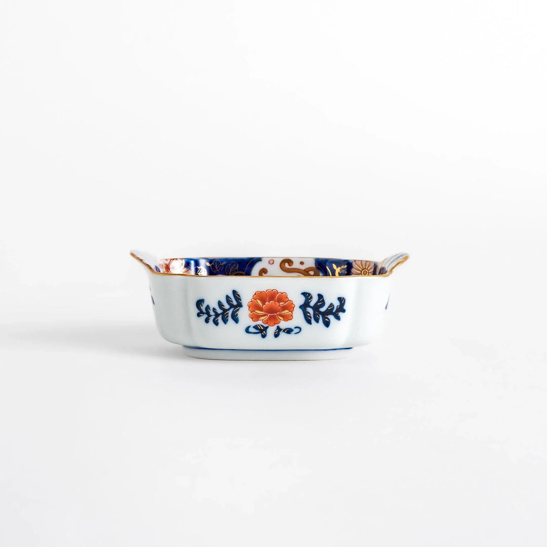 Vibrant condiment bowl with pine bamboo and plum motifs cranes and gold details and flared edge design.