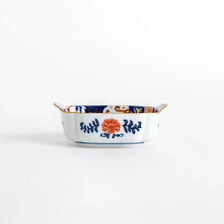 Vibrant condiment bowl with pine bamboo and plum motifs cranes and gold details and flared edge design.