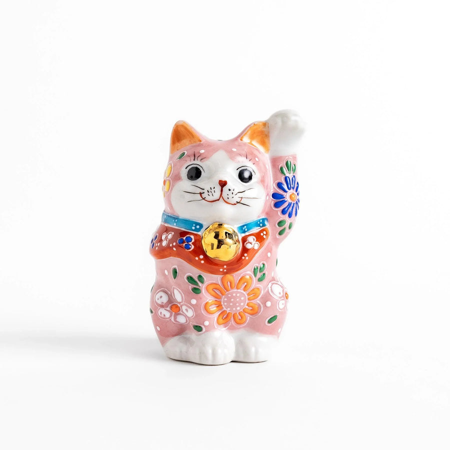 Pink blossom Maneki Neko figurine with floral patterns and gold bell symbolizing good luck and prosperity.