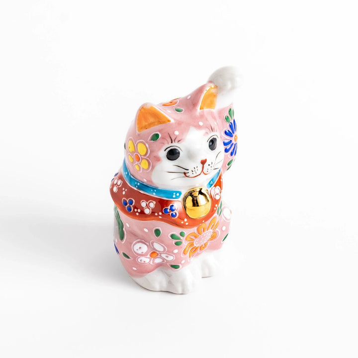 Pink blossom Maneki Neko figurine with floral patterns and gold bell symbolizing good luck and prosperity.