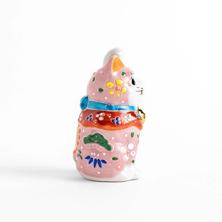 Pink blossom Maneki Neko figurine with floral patterns and gold bell symbolizing good luck and prosperity.
